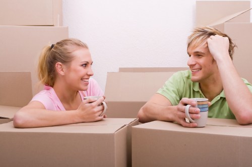 Professional movers carrying furniture through a residential building
