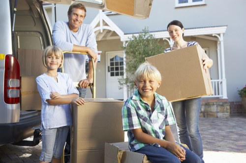 Unpacking support in a Kidbrooke apartment with labelled moving boxes